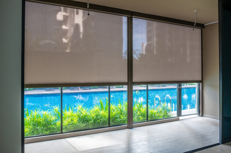 View of tampines tapestry poolside condo unit with Zipscreen outdoor track blinds overlooking a swimming pool.