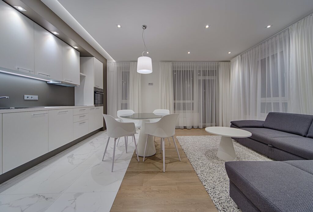 contemporary apartment living room with kitchen and flowy day curtains