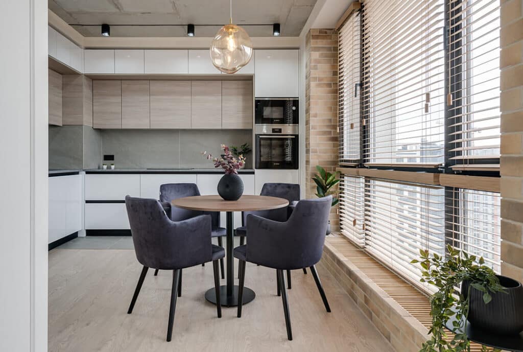 Sleek and modern kitchen featuring Venetian blinds, stainless steel appliances, and a modern rustic design.