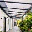 Tinted polycarbonate roof canopy providing bright shelter for balcony